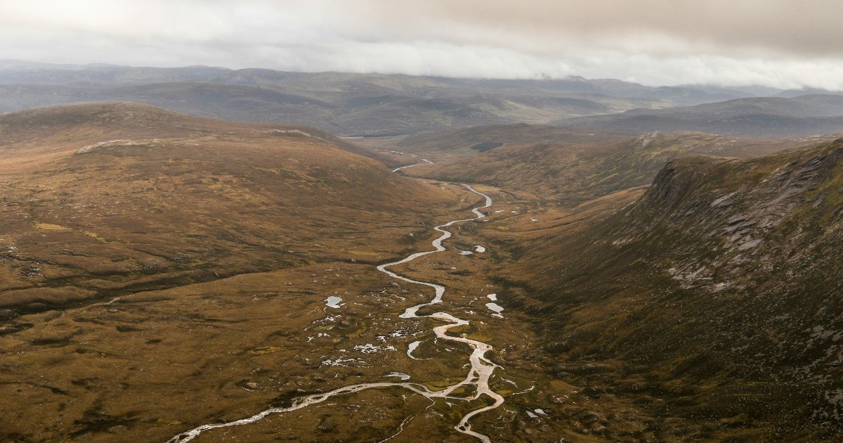 River flows between munros