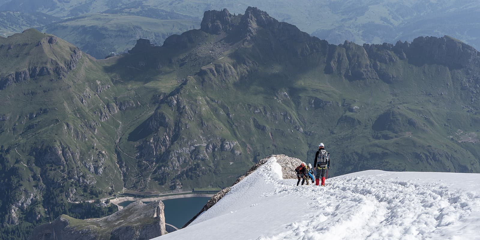 group of hikers going down on snow covered mountain