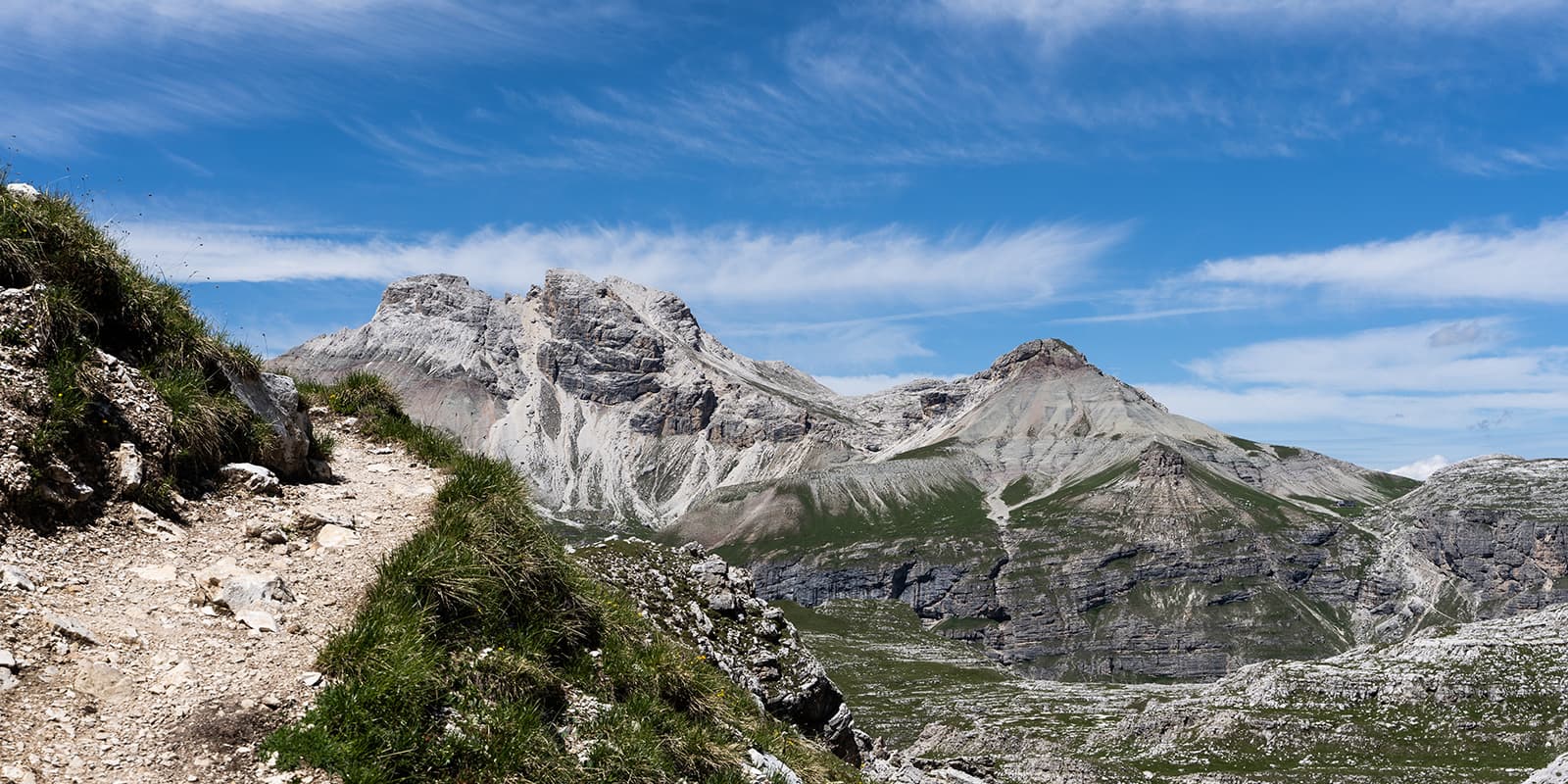 small mountain path on the side of dolomites mountains