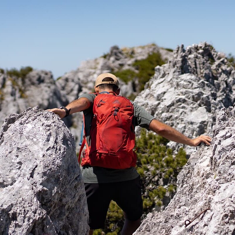 person going between sharp rocks in Austrian Alps