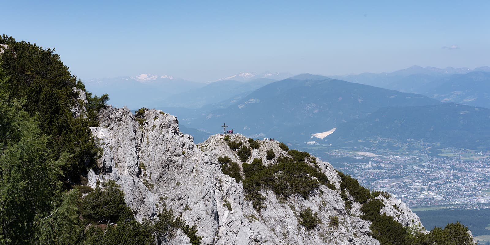 mountain peak on the Alpe Adria Trail looking out over city below