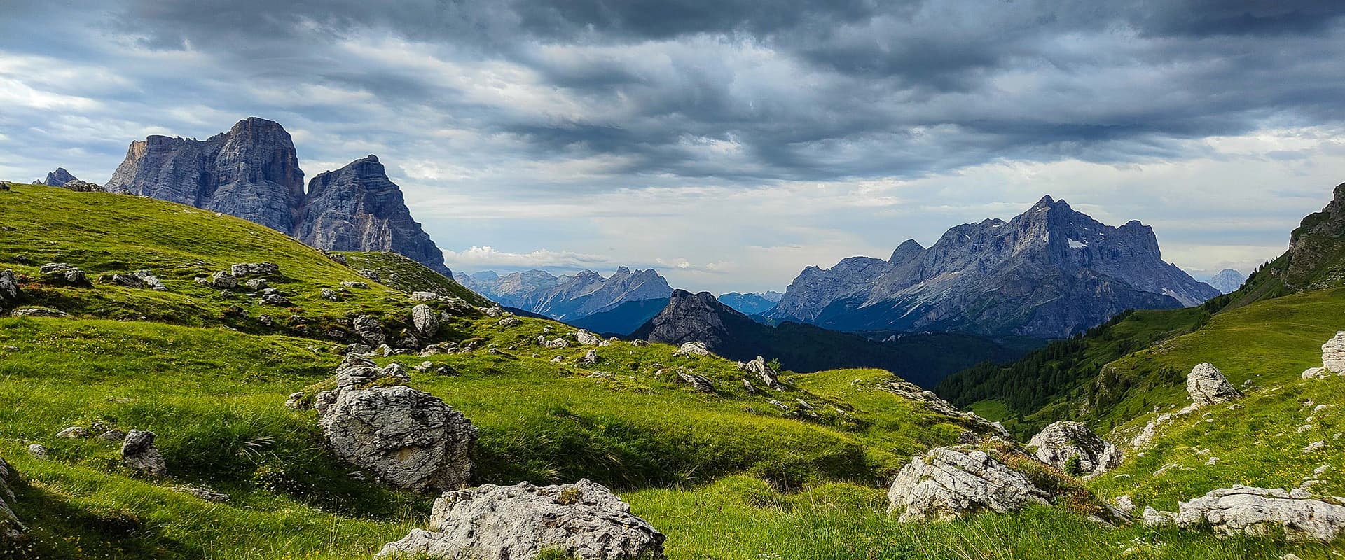 green landscape and rugged mountain peaks on the Alta Via 1 in the Dolomites