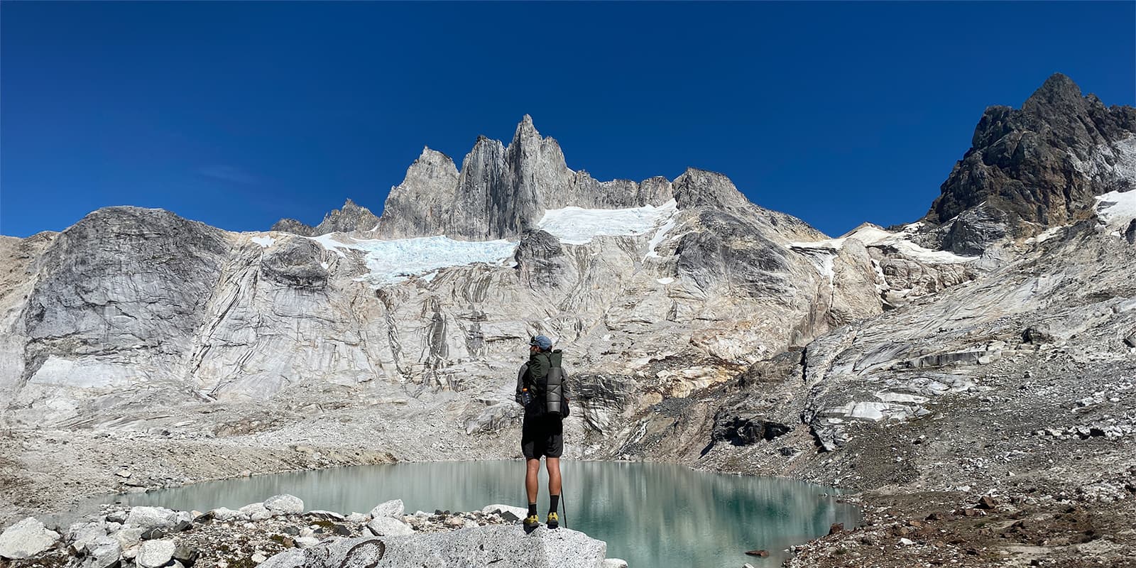 man standing on rock looking out over the mountains in Patagonia