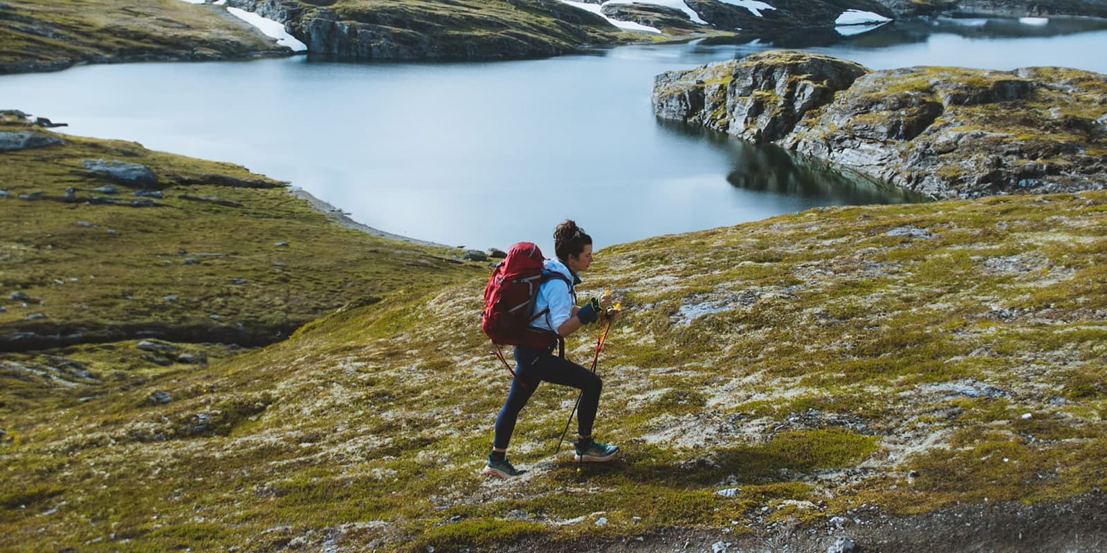 women hiking in Norway on grassy field