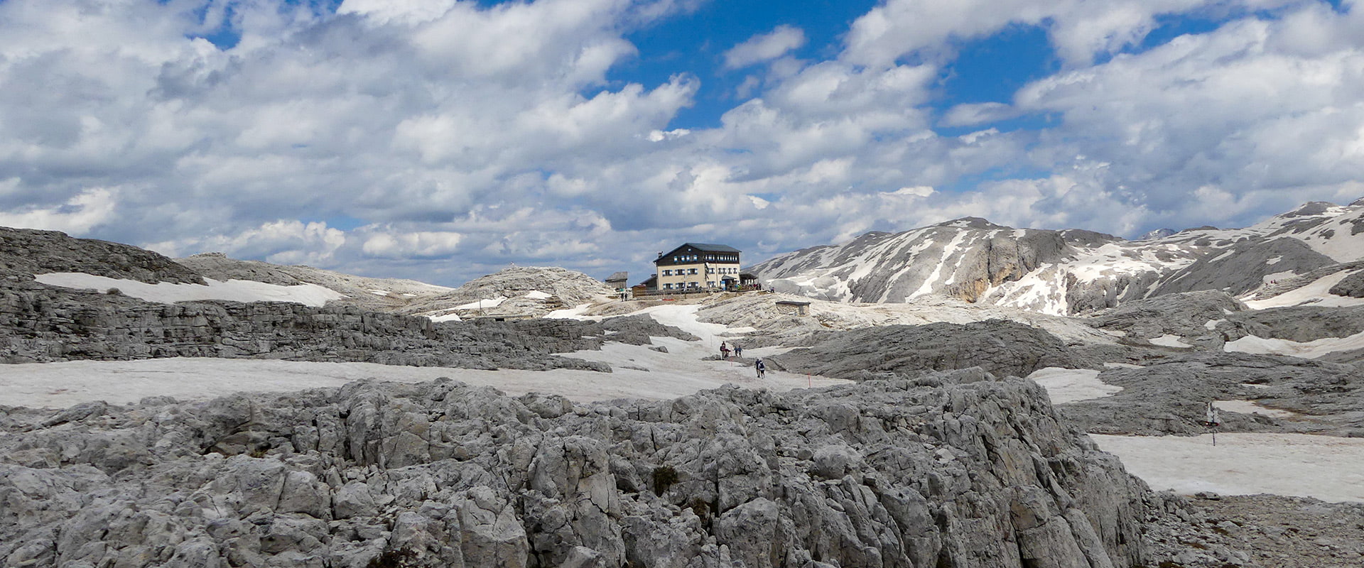 mountain hut between snow covered peaks in Dolomites, Italy.