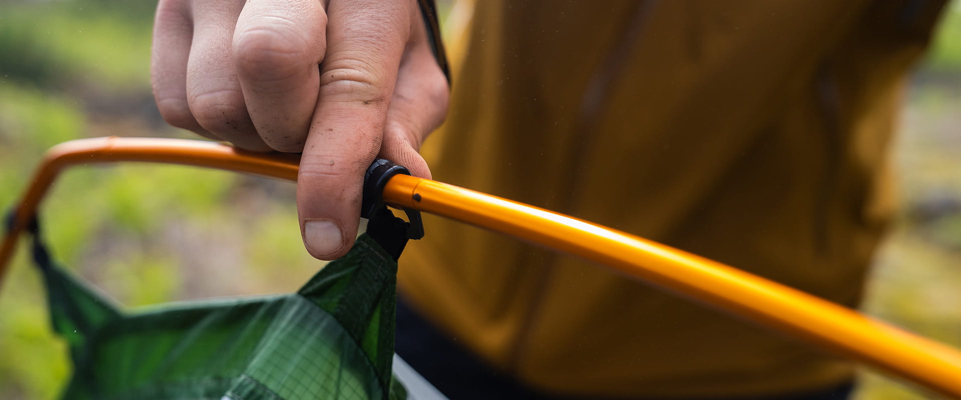 Close up of person pitching tent