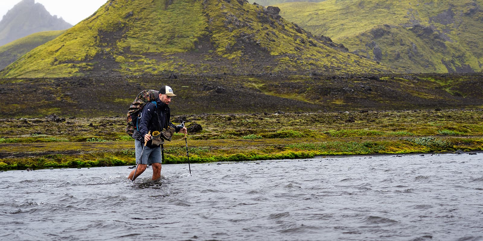 person crossing river on the Iceland trail