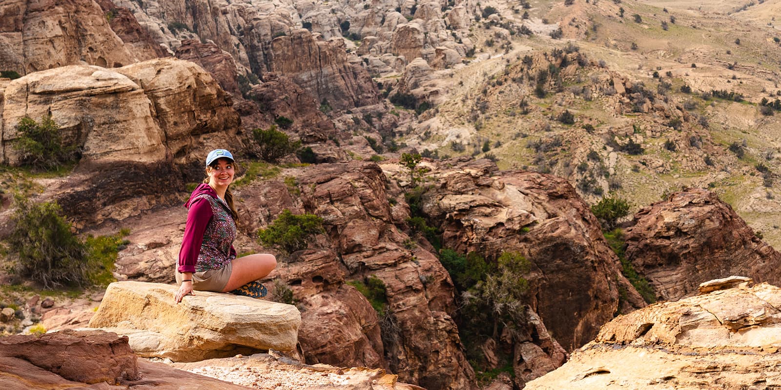 women sitting on rock in Jordan desert