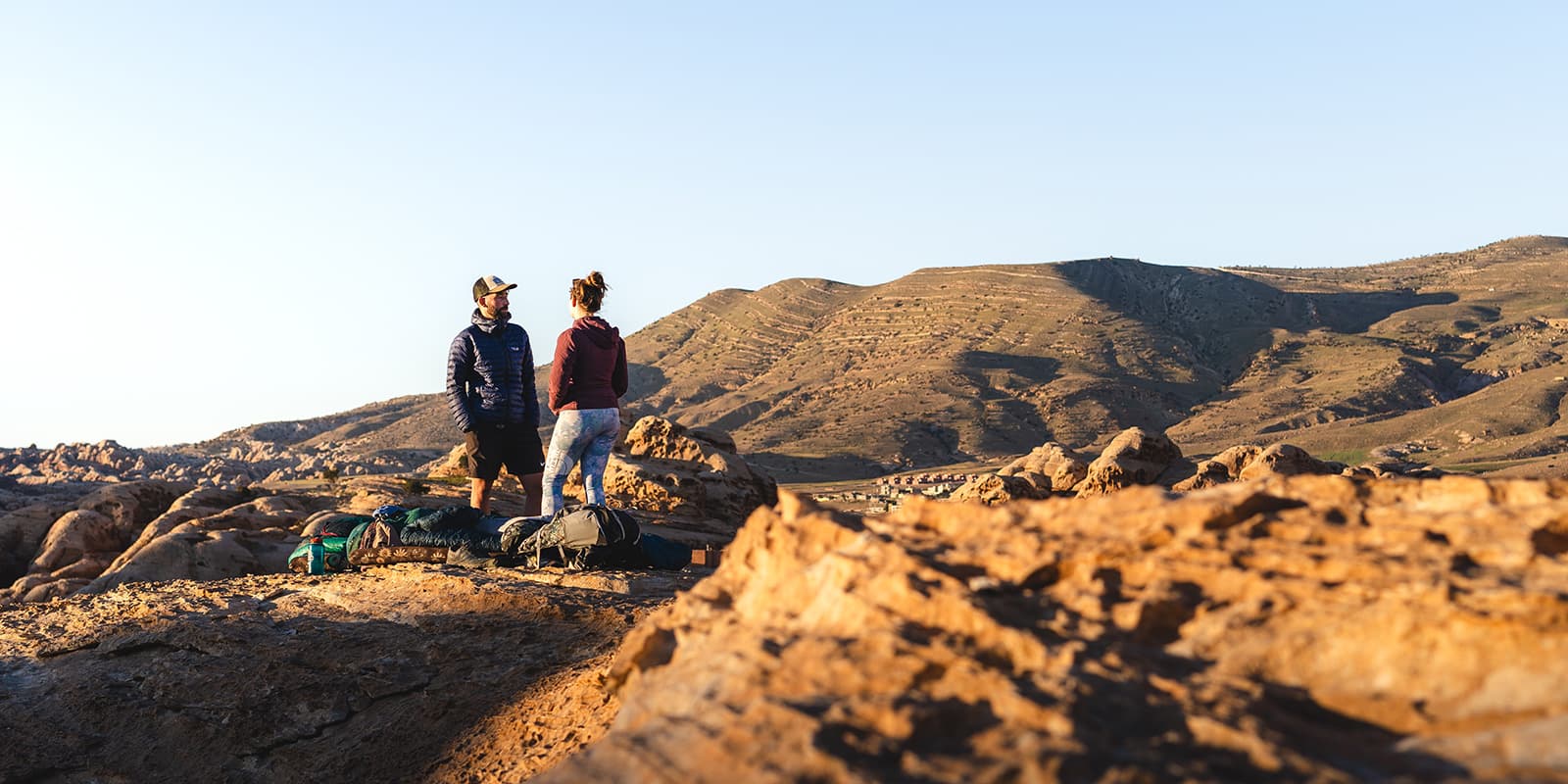 two persons camping outside in Jordan during sunset