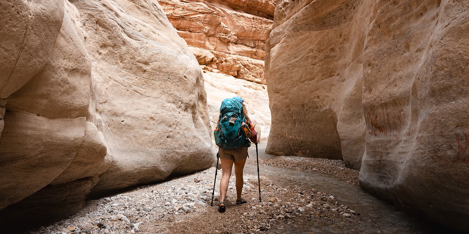 person hiking between large rock formations