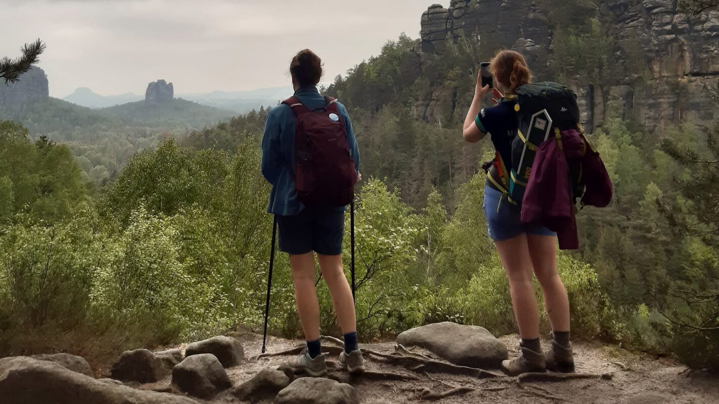 two women looking out over forest an mountains on the Malerweg