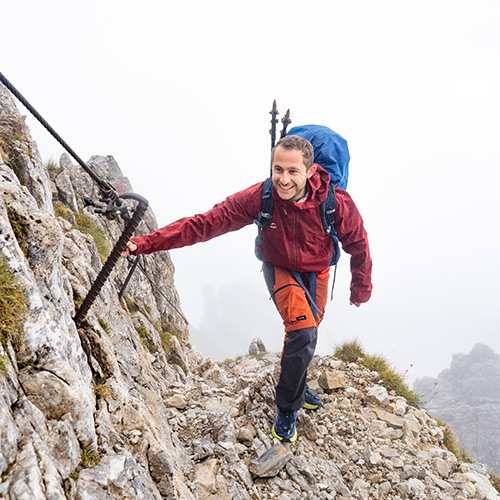 man hiking up mountain