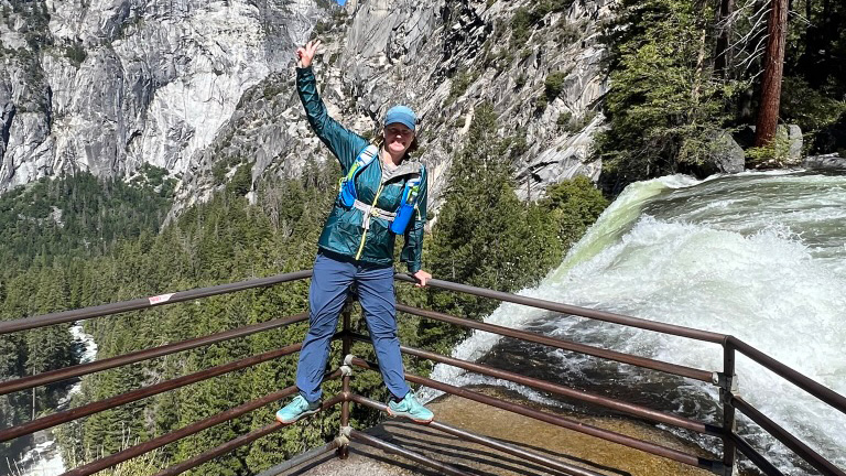 women posing for camera near waterfall