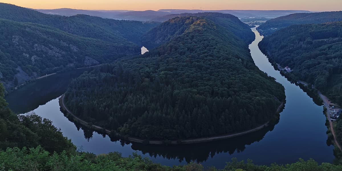 river meandering around green hills in Germany