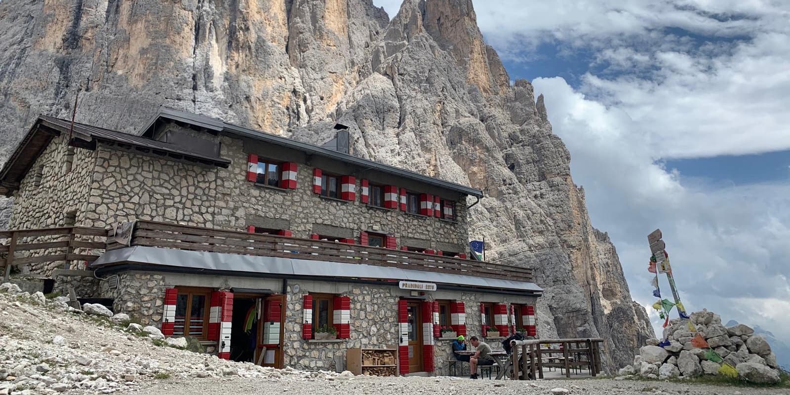 Stone Mountain hut in front of rugged peaks in the dolomites