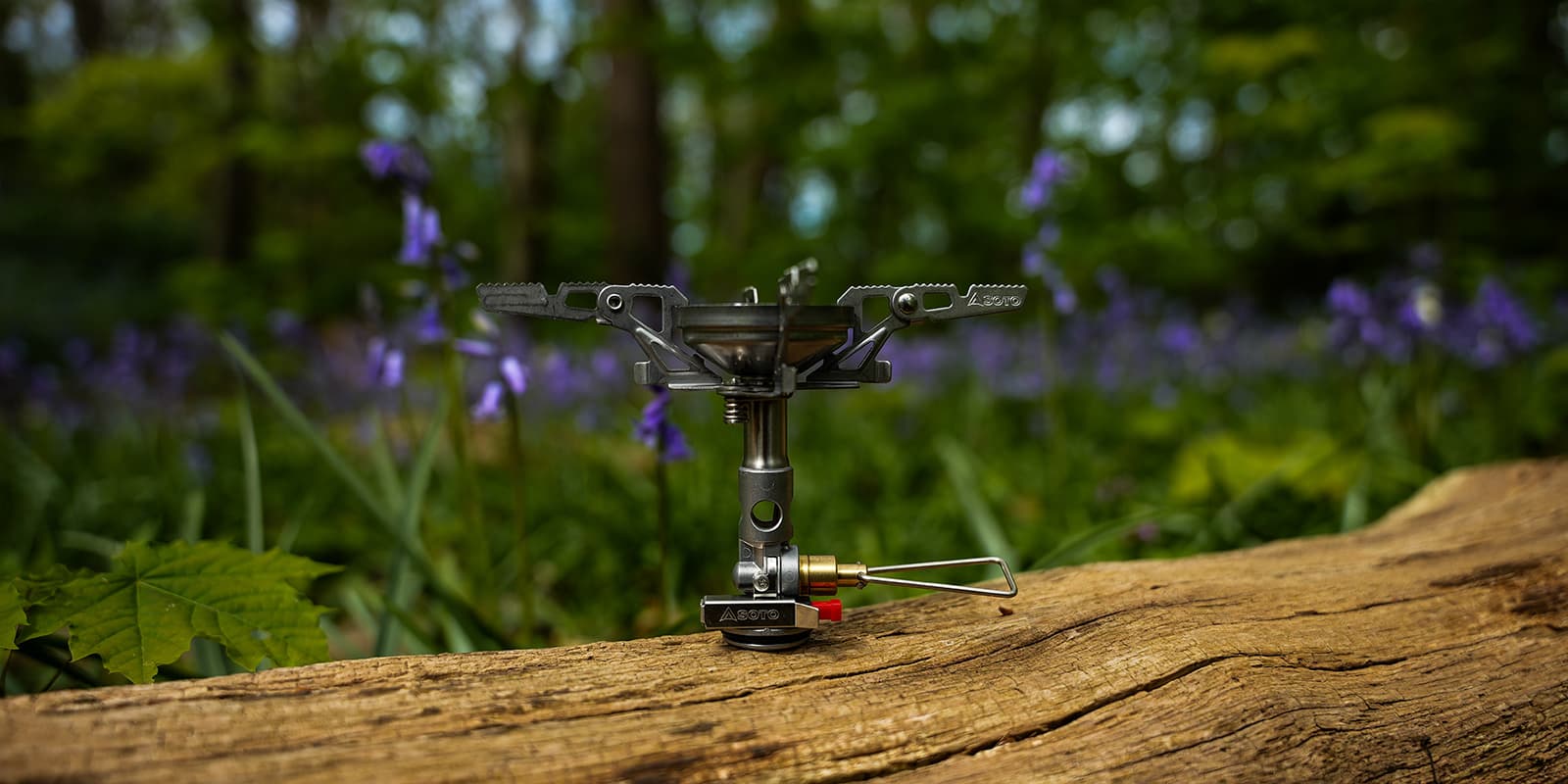 camping stove on wooden log