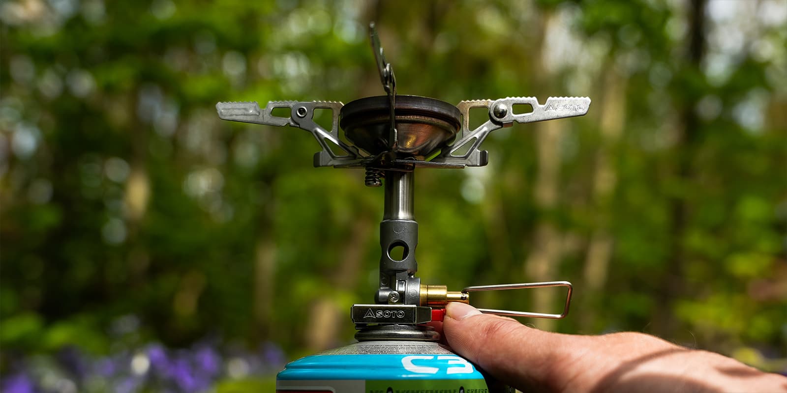 person putting on the SOTO WindMaster stove