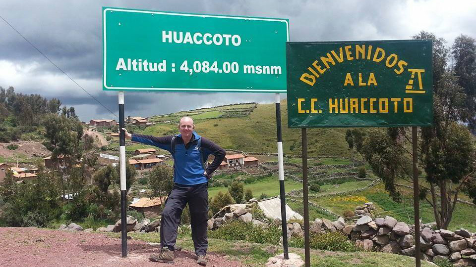 man standing by sign on 4000m altitude