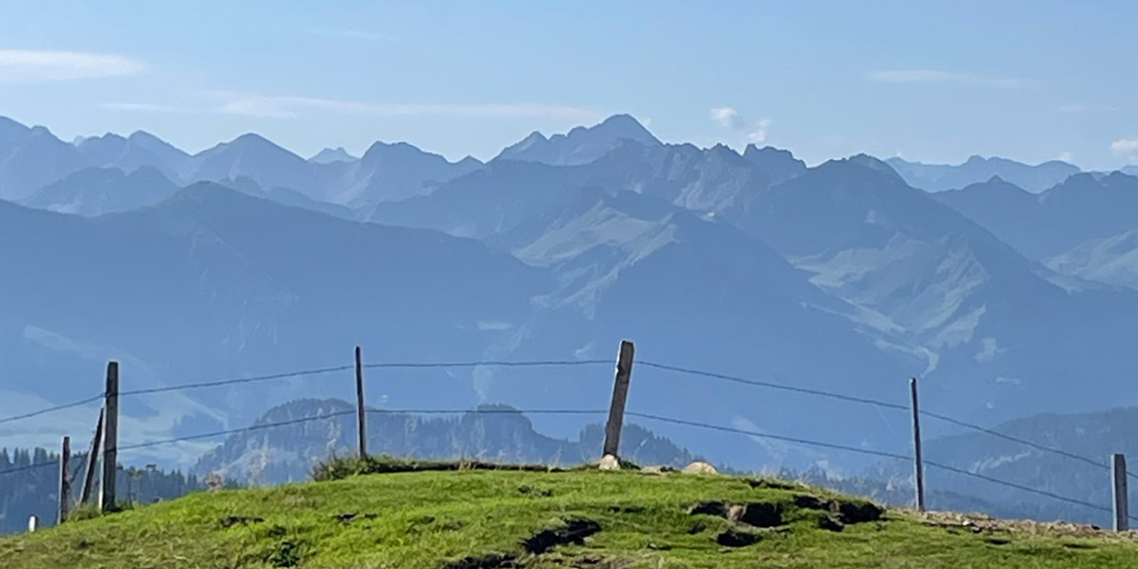 wired fence with German alps in the background