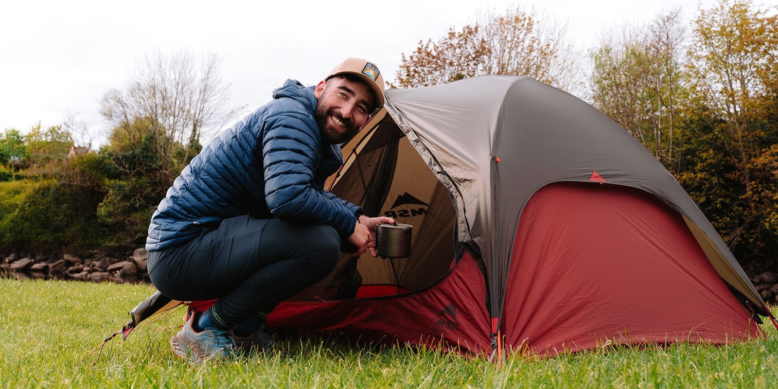 man sitting in front of his MSR tent 