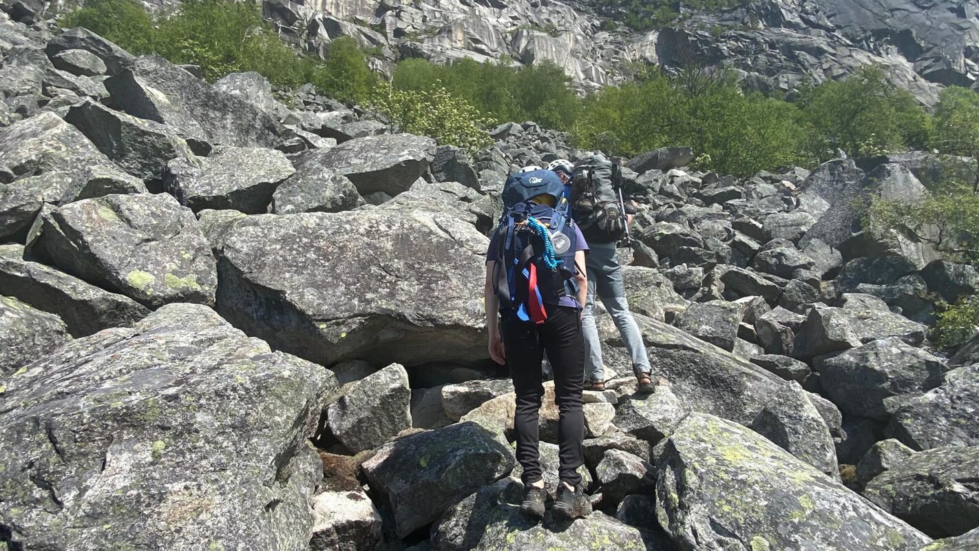 two persons hiking on rocky surface