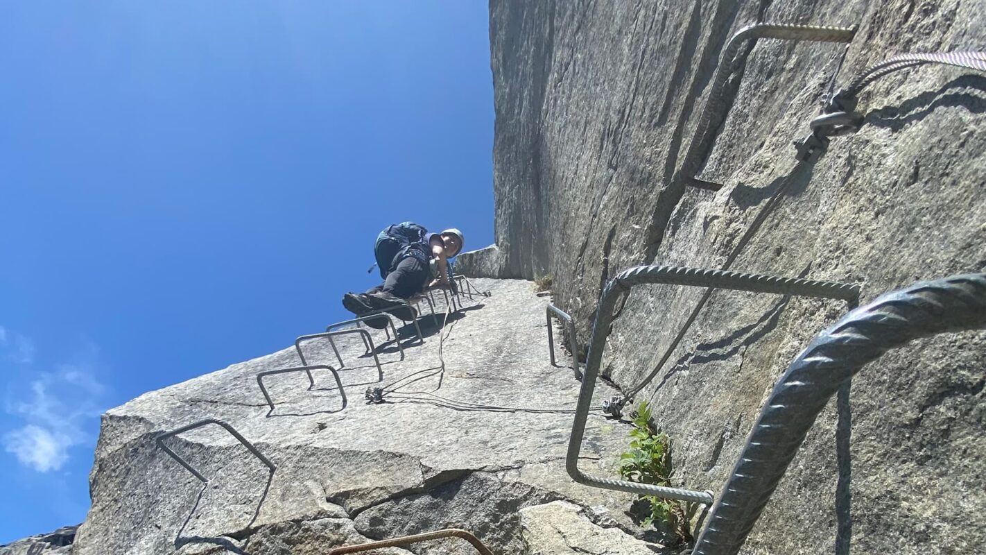 upwards taken photo om someone climbing up mountain cliff