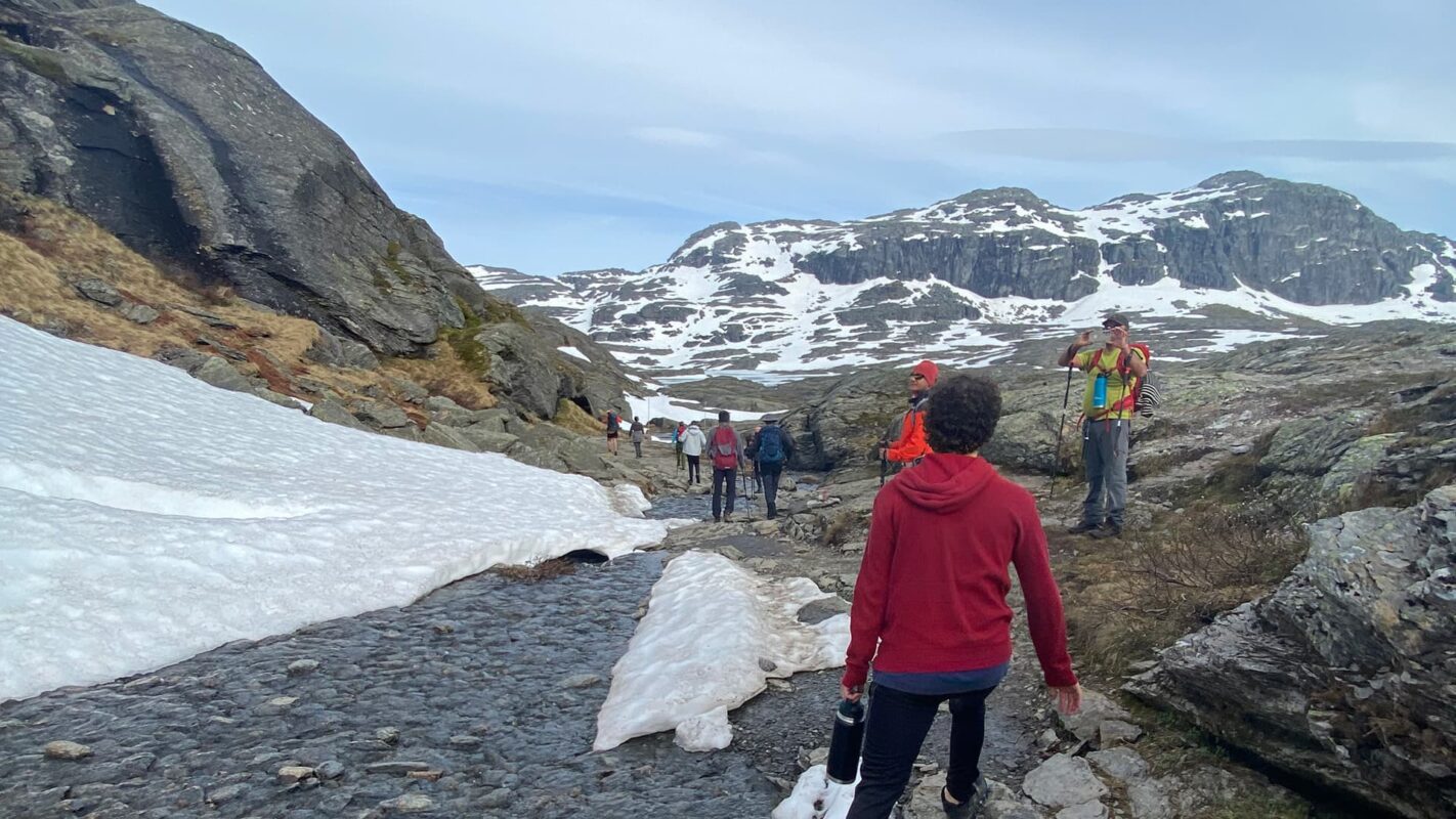 group of hikers in snow covered mountain valley