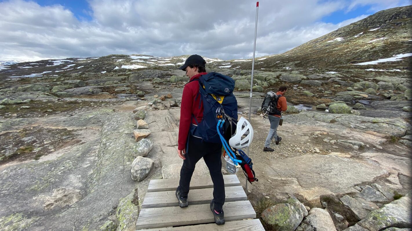 person with via ferrata kit hiking in mountain landscape