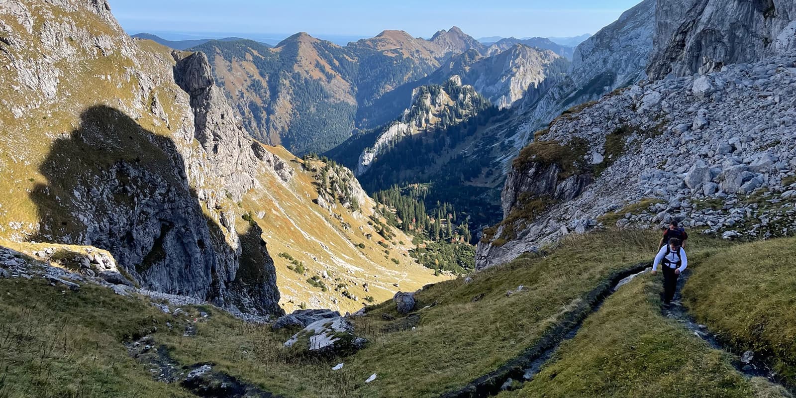 two persons hiking up small mountain path in Germany