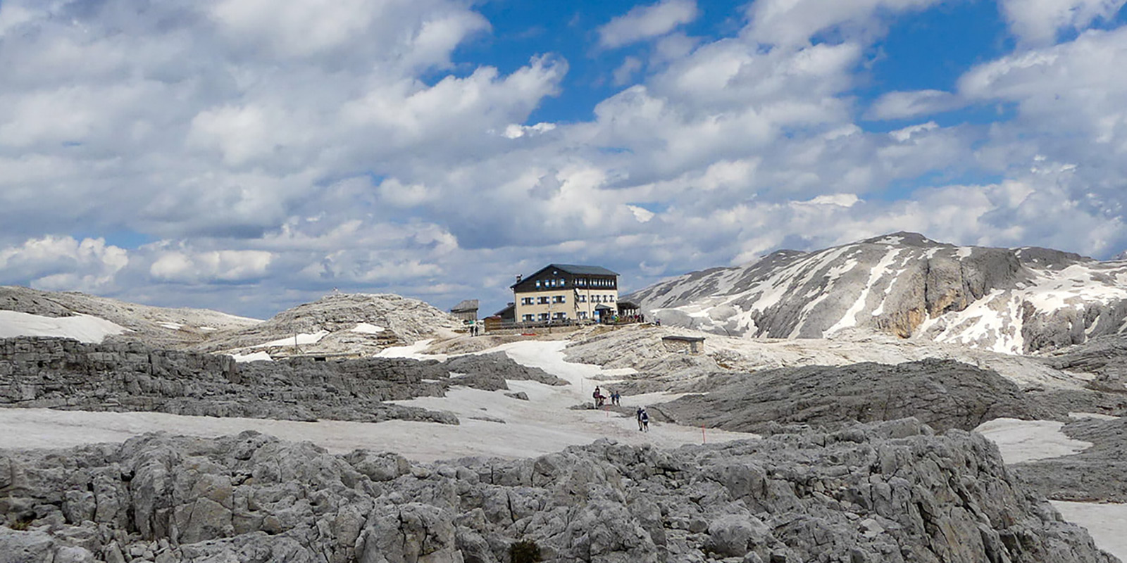 mountain hut between snow covered peaks in Dolomites, Italy.