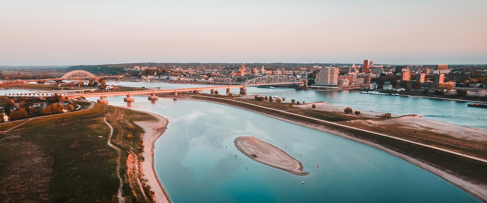 view of a river flowing next to the city of Nijmegen