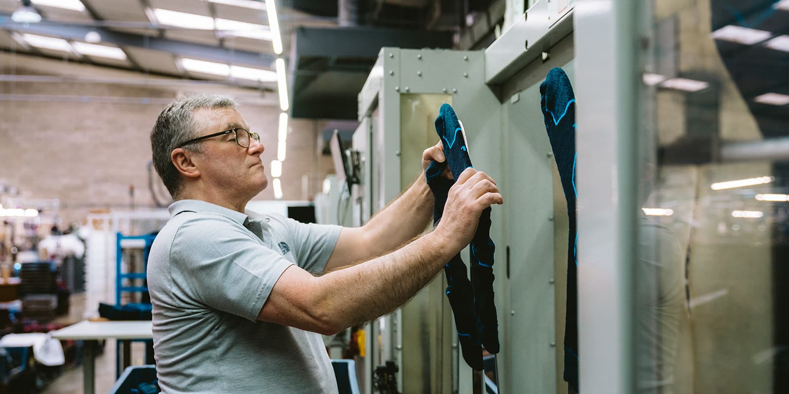 person checking socks in factory