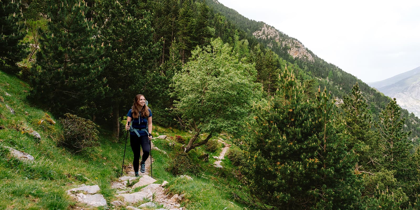 women hiking in green forest in the Catalan pyrenees