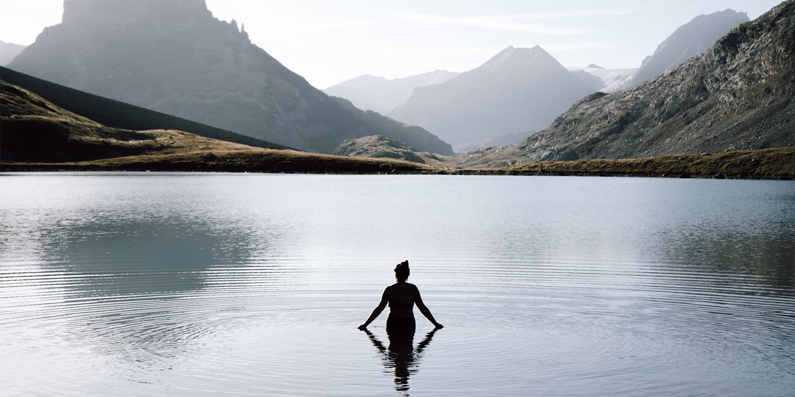 women swimming in alpine lake