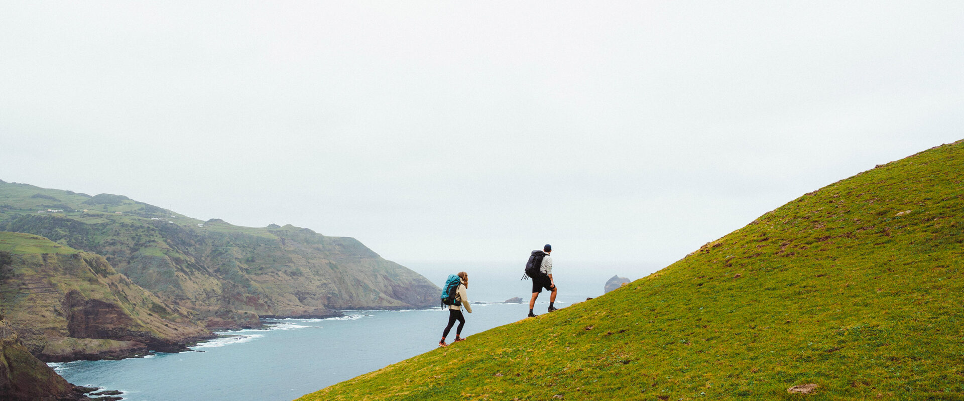 couple hiking on the Azores with Osprey backpacks