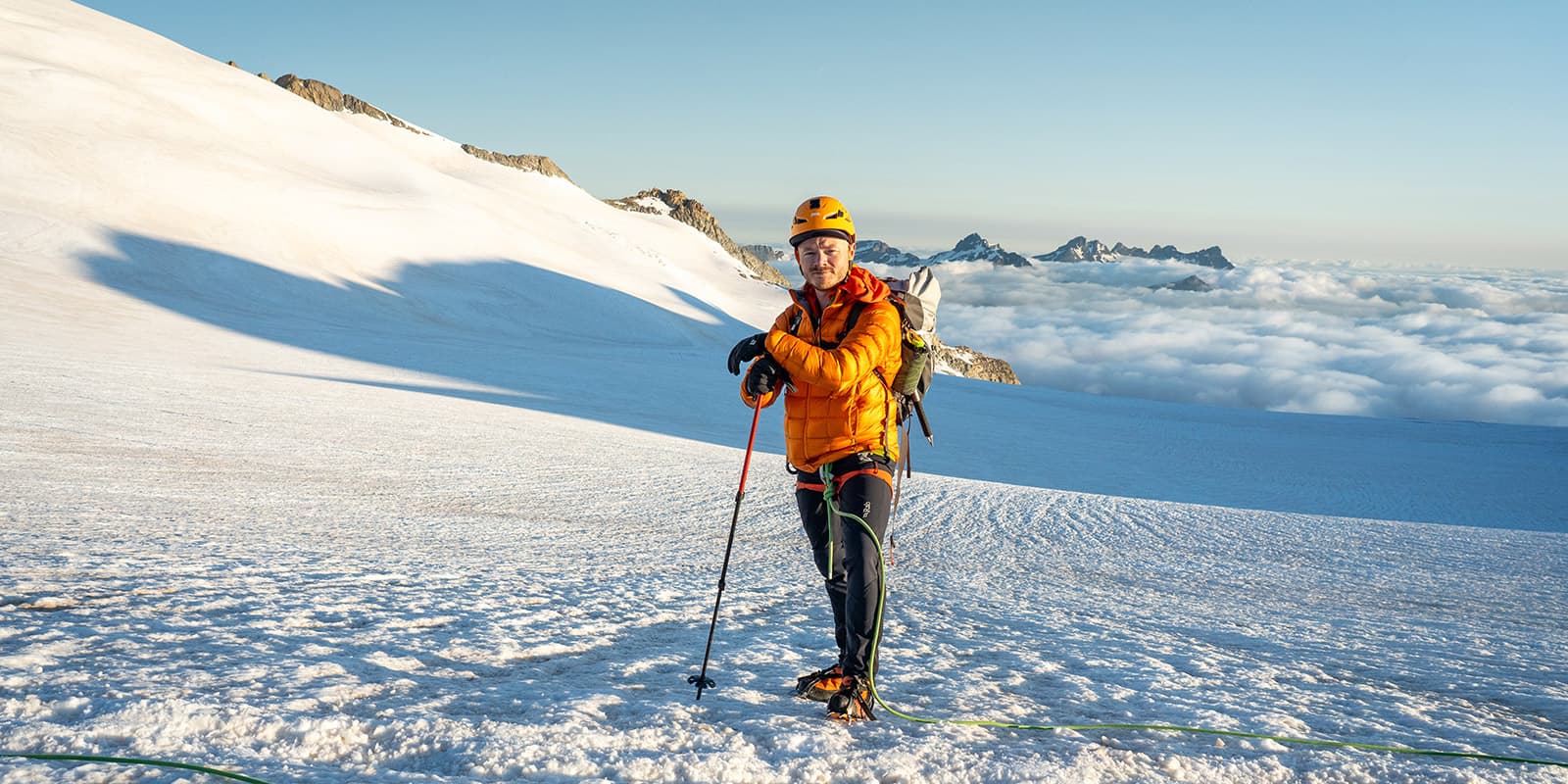 man in full alpine gear on snowy mountains