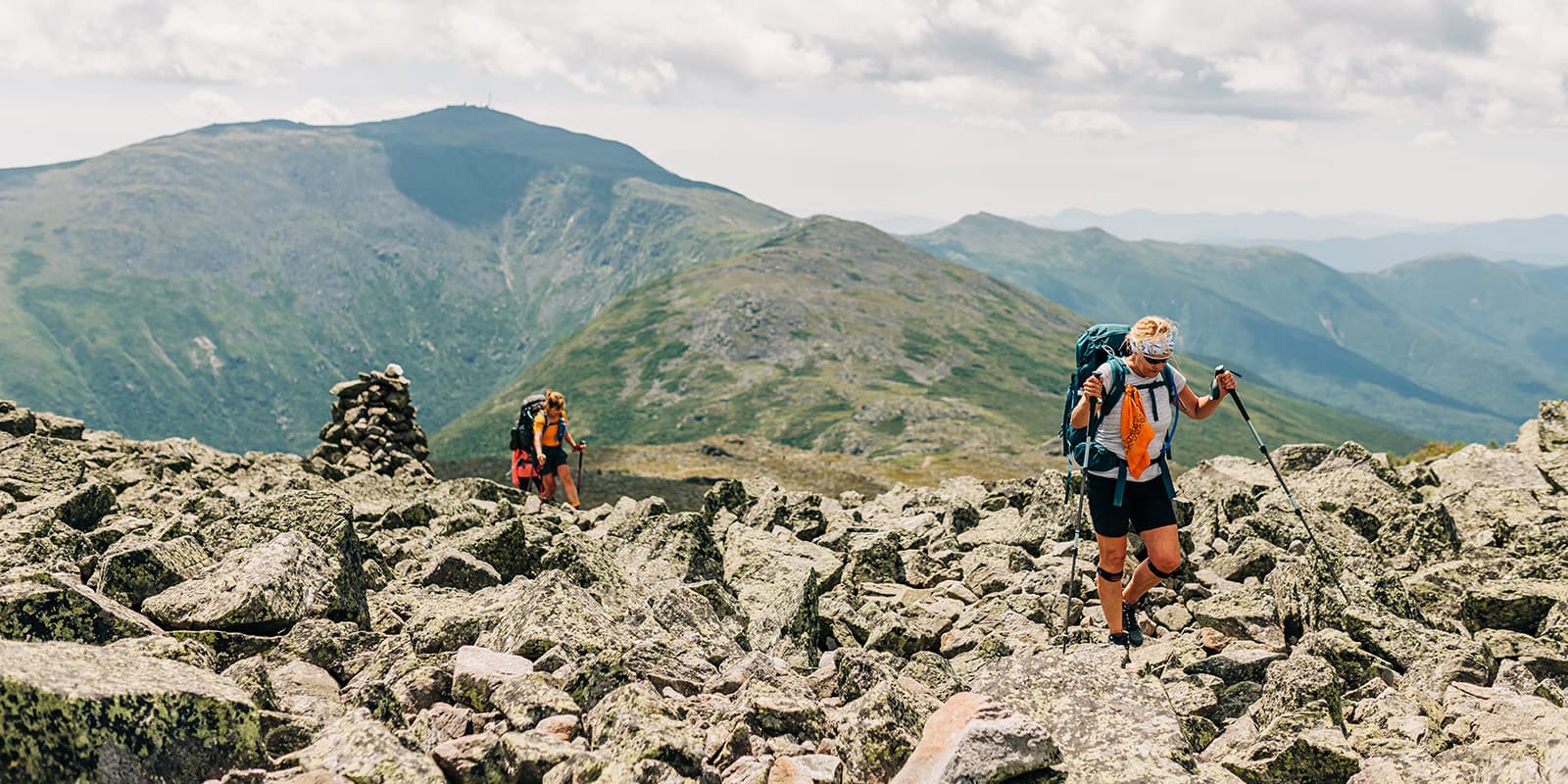 person hiking on rocky surface on the Appalachian hut to hut tour