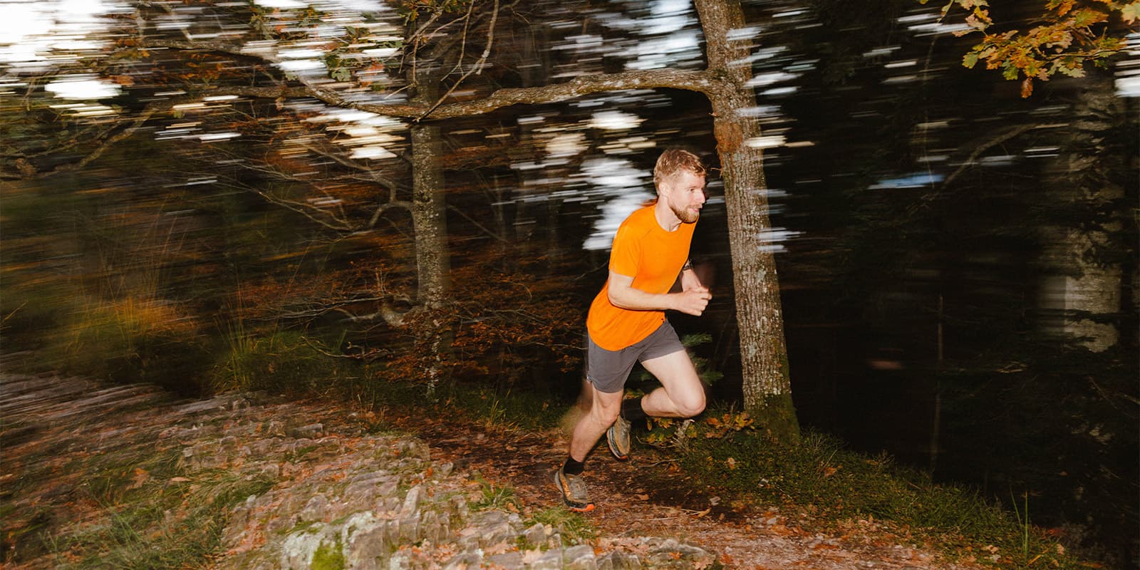 man running on forest path