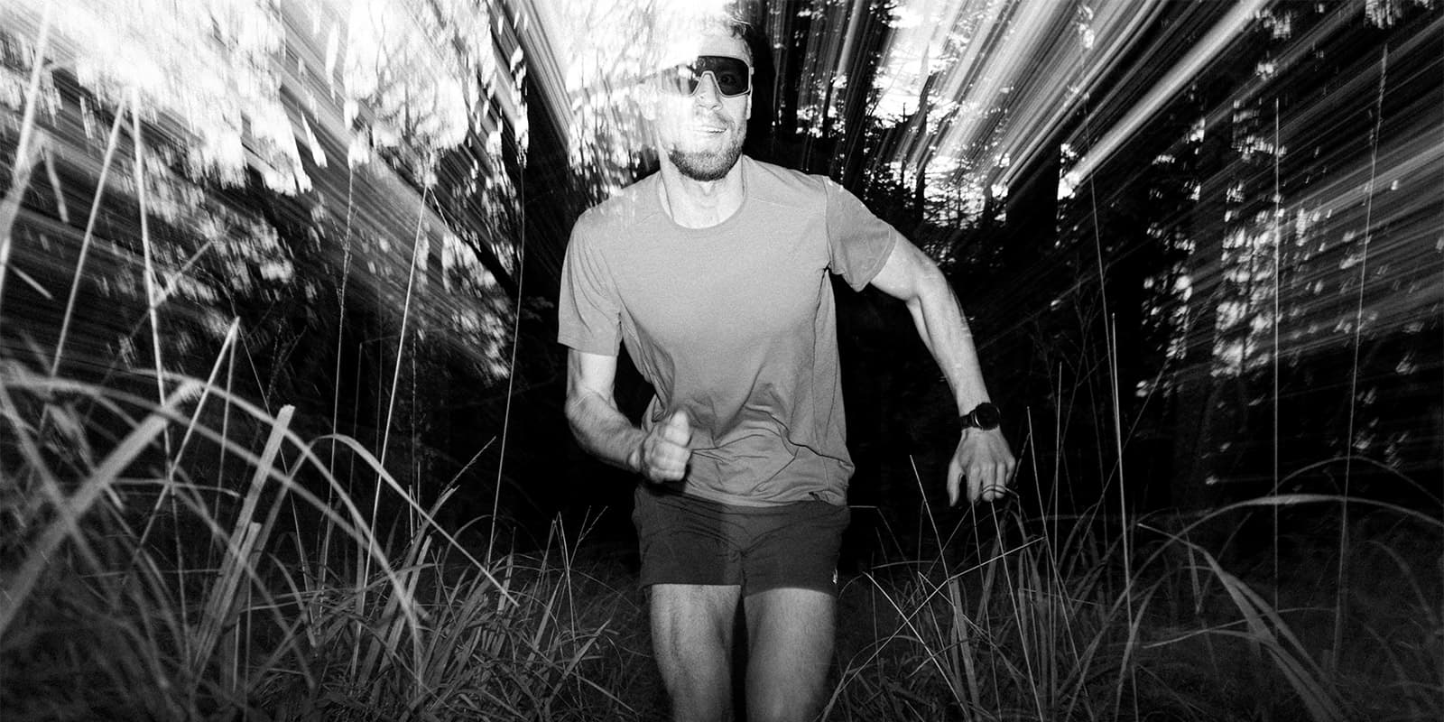 long exposure shot of man running in forest