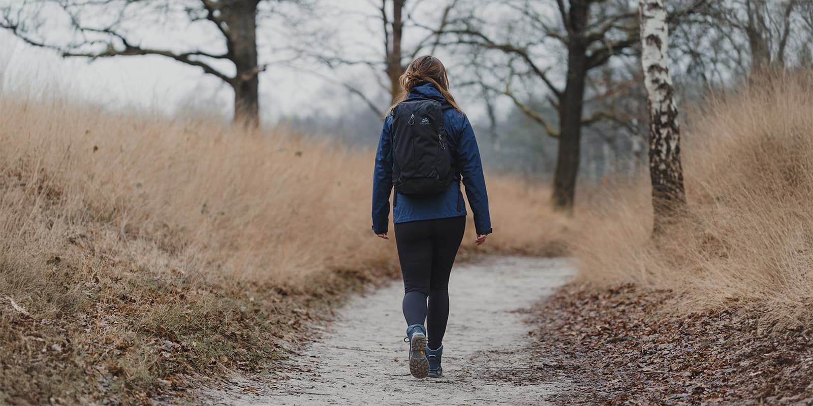 person hiking on unpaved path