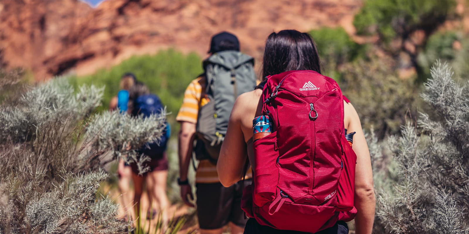 women hiking with Gregory Jade 24LT in ruby red