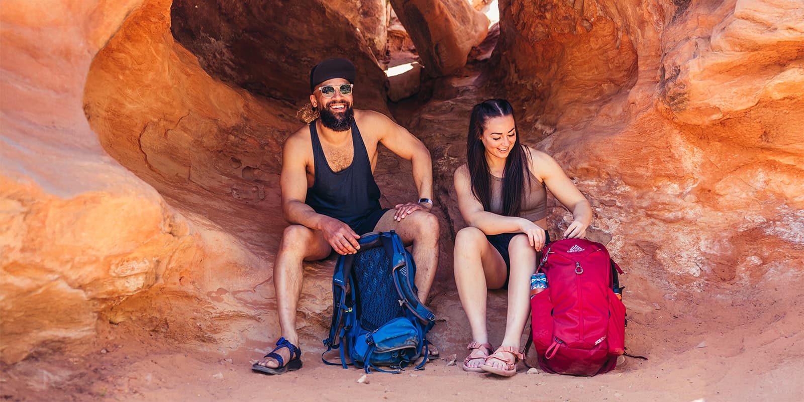 man and women sitting on desert rocks