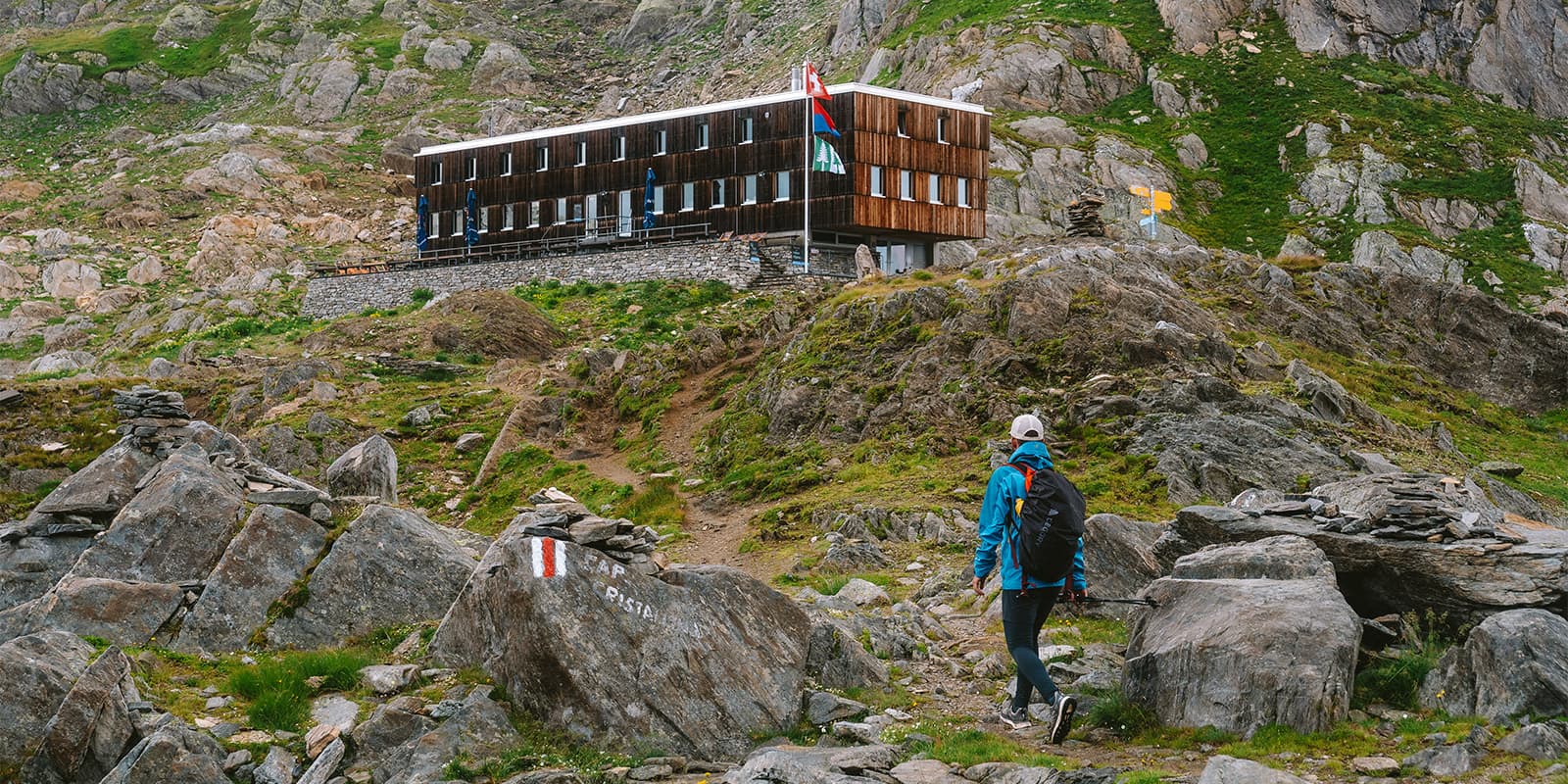 person hiking up to mountain hut in Ticino