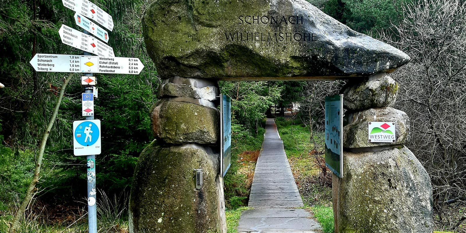 wooden pathway leading up to stone arch on the Westweg hiking trail