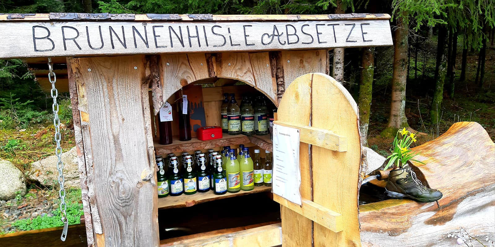 small wooden cabinet filled with drinks in the black forest