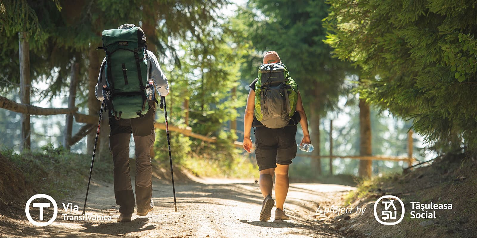 two people hiking on ar dirt road on the via transilvanica