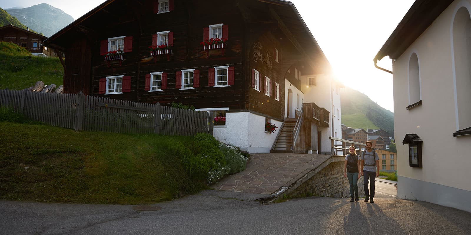 two people hiking in the town of Warth on the Lechweg