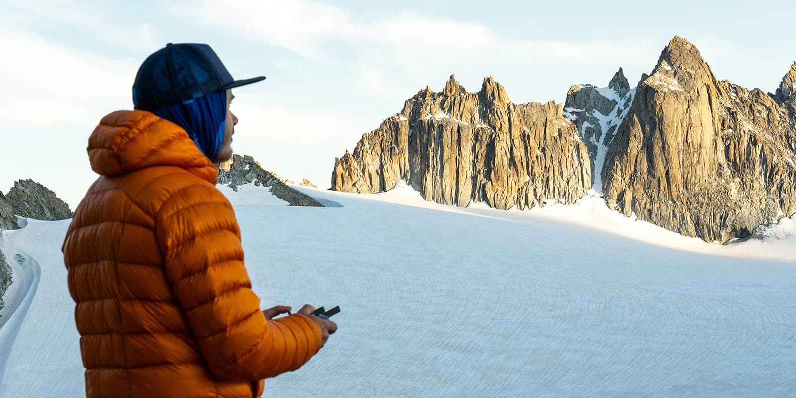 person looking out over glacier and mountains