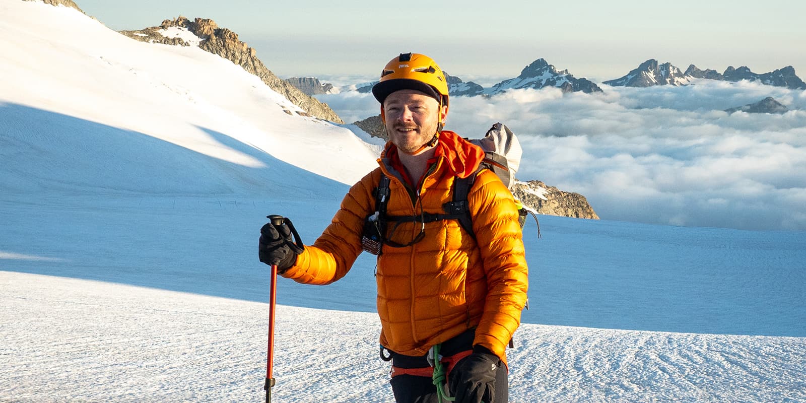 person on top of glacier wearing the RAB mythic alpine down jacket