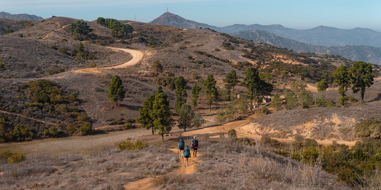 three persons hiking on the Trans-Catalina trail in California